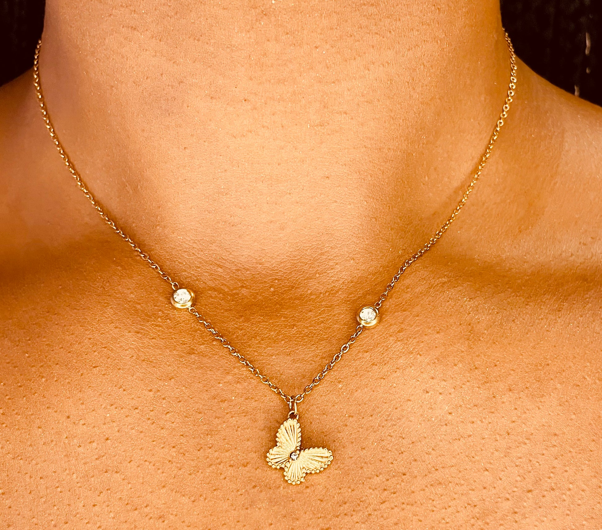 Stylish 18K gold plated butterfly necklace worn by a model, highlighting its delicate design from GeorgiaReneeBoutique.