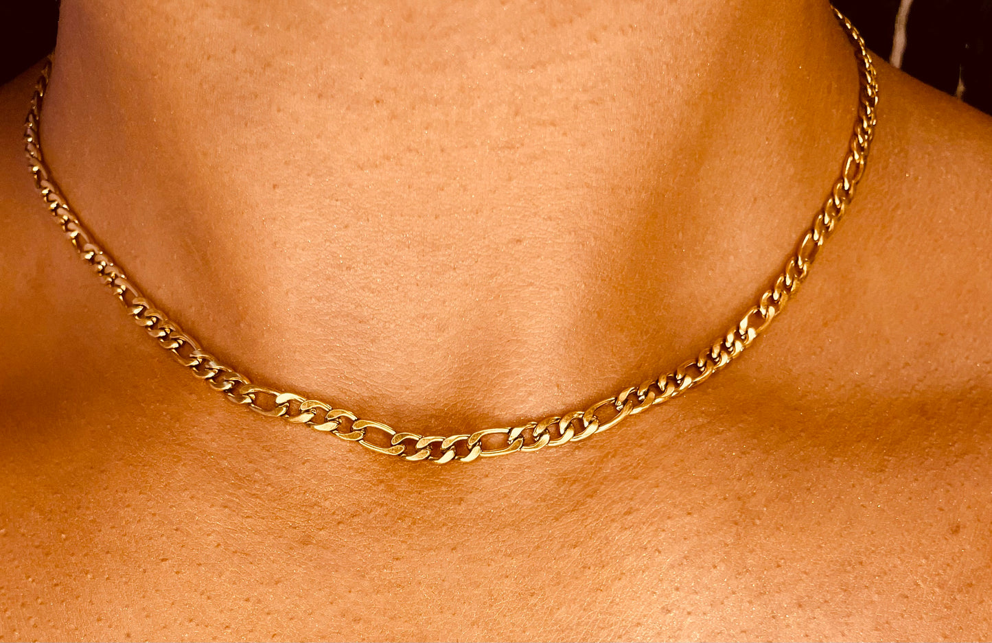 Side view of tarnish-proof 18K gold plated steel necklace, featuring a sleek and sophisticated design.