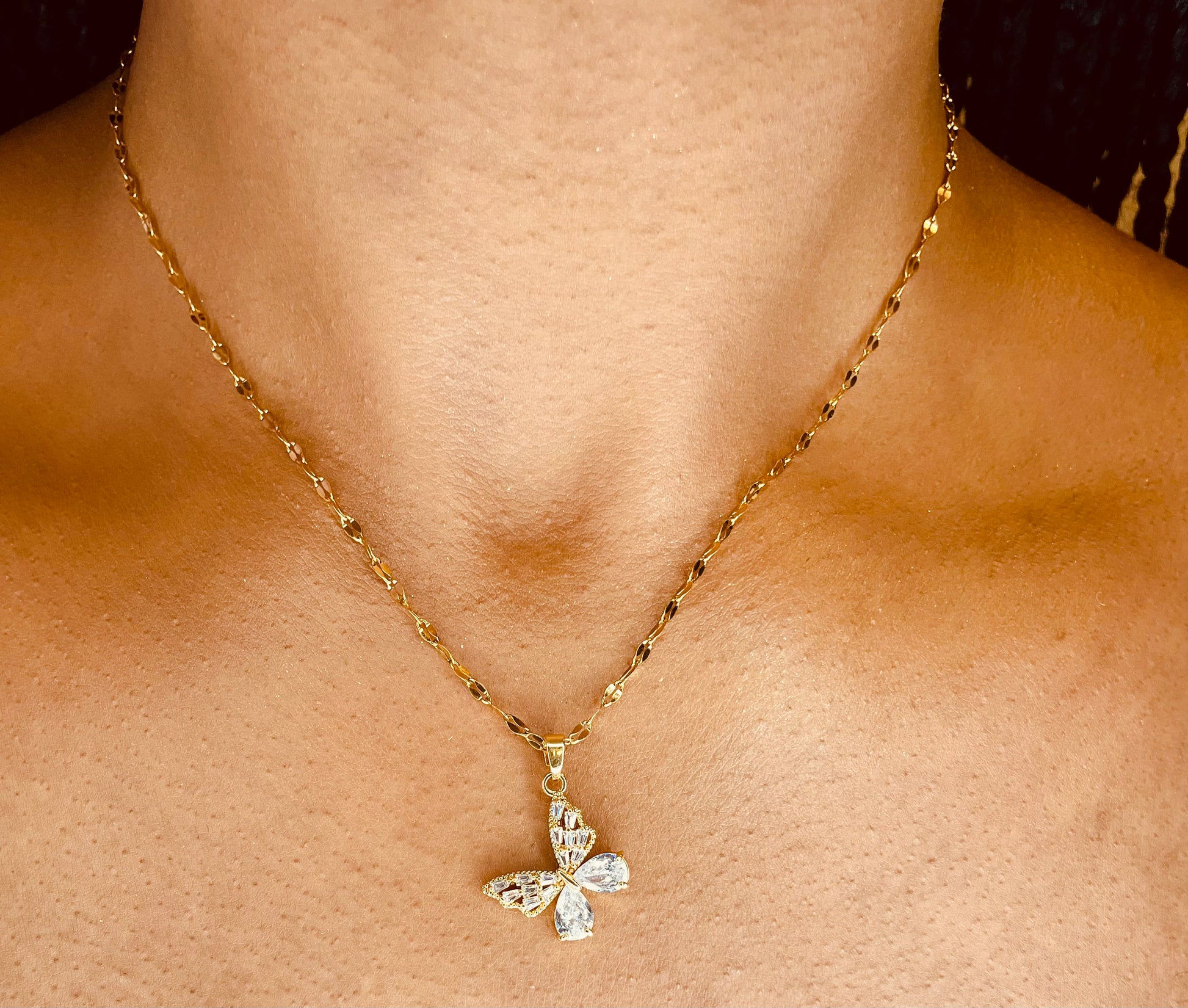 Stylish 18K gold plated steel butterfly necklace worn by a model, highlighting its delicate design from GeorgiaReneeBoutique.
