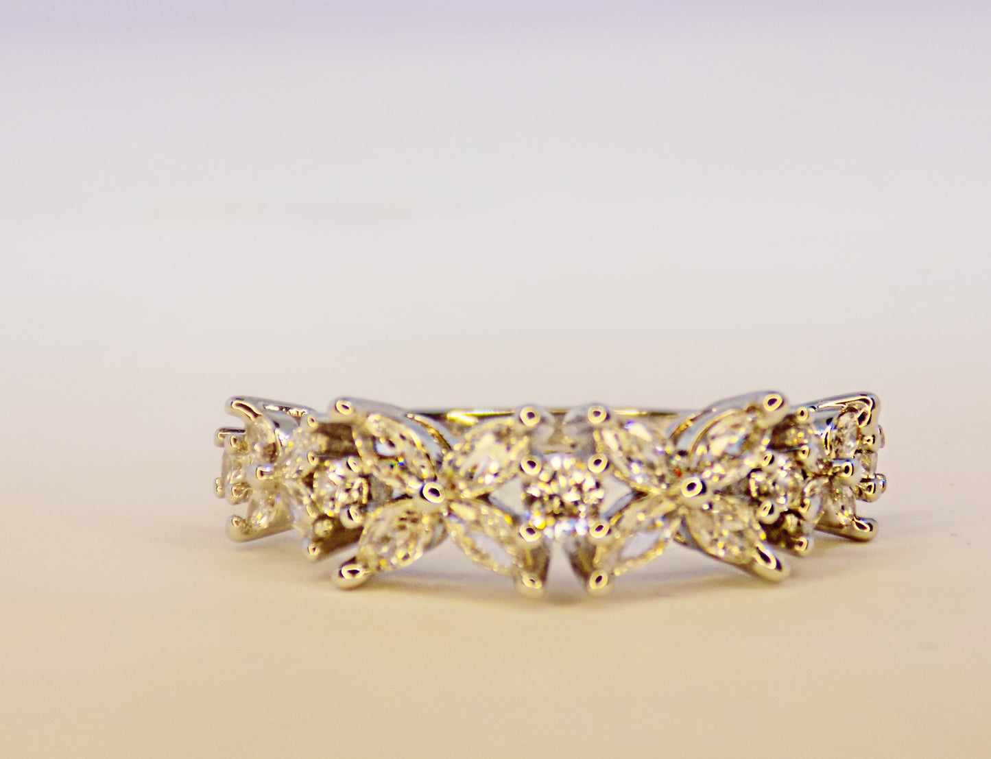 Handmade Lorelei eternity band ring in 925 sterling silver, adorned with cubic zirconia, displayed on hand.