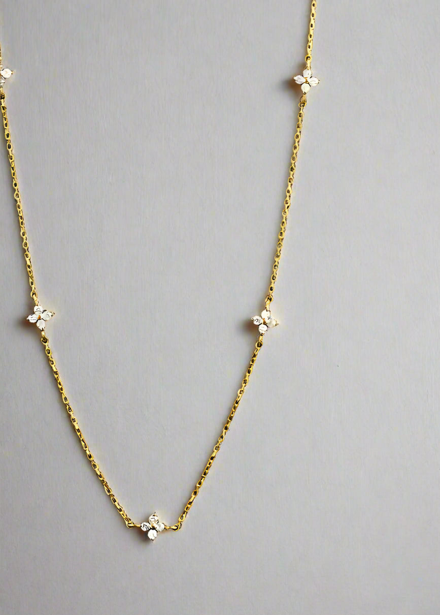 “Delicate four-leaf clover charm necklace in 18k gold plated sterling silver, minimalist jewelry style”