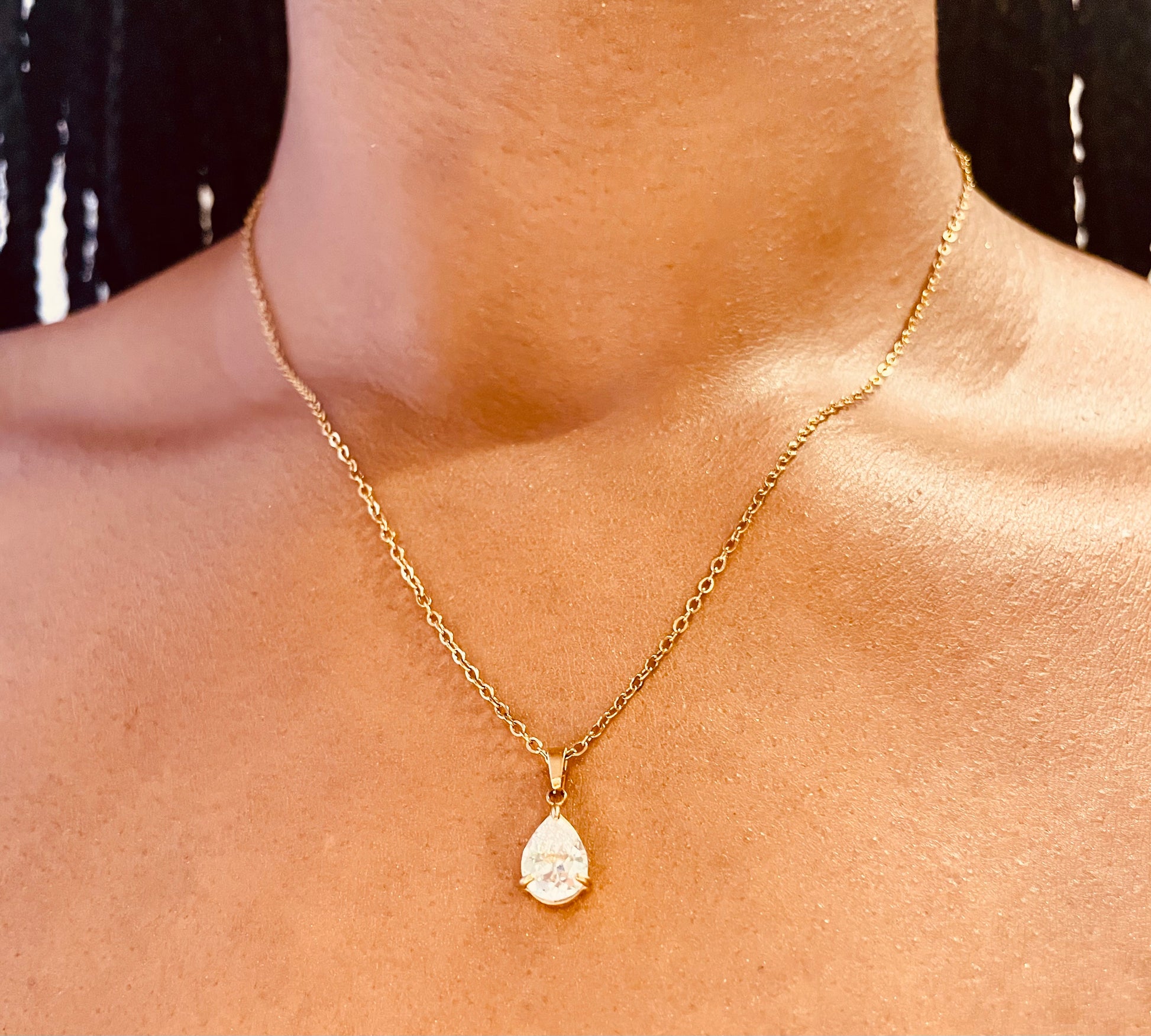 Close-up of tarnish-proof 18K gold plated pear drop necklace, showcasing intricate pendant details for lasting elegance.