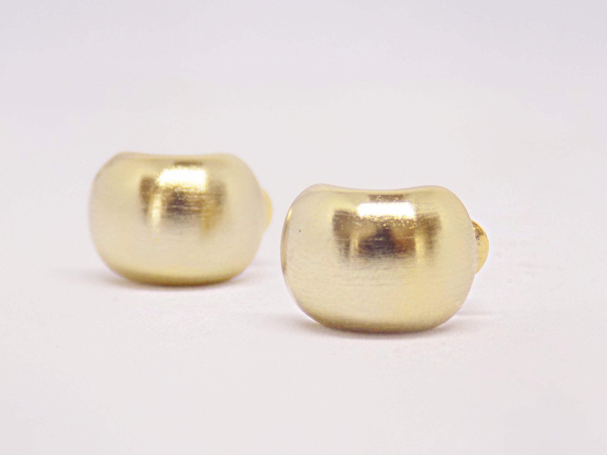  Side view of tarnish-proof 14K gold plated smooth circular minimalist stud earring, featuring a sleek and modern design.