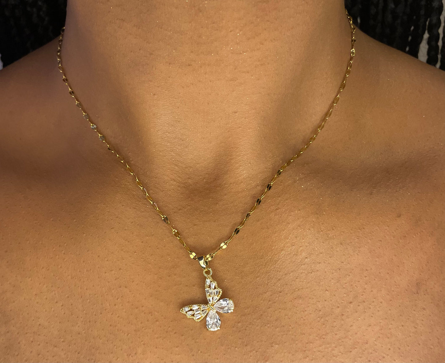 Stylish 18K gold plated steel butterfly necklace worn by a model, highlighting its delicate design from GeorgiaReneeBoutique.
