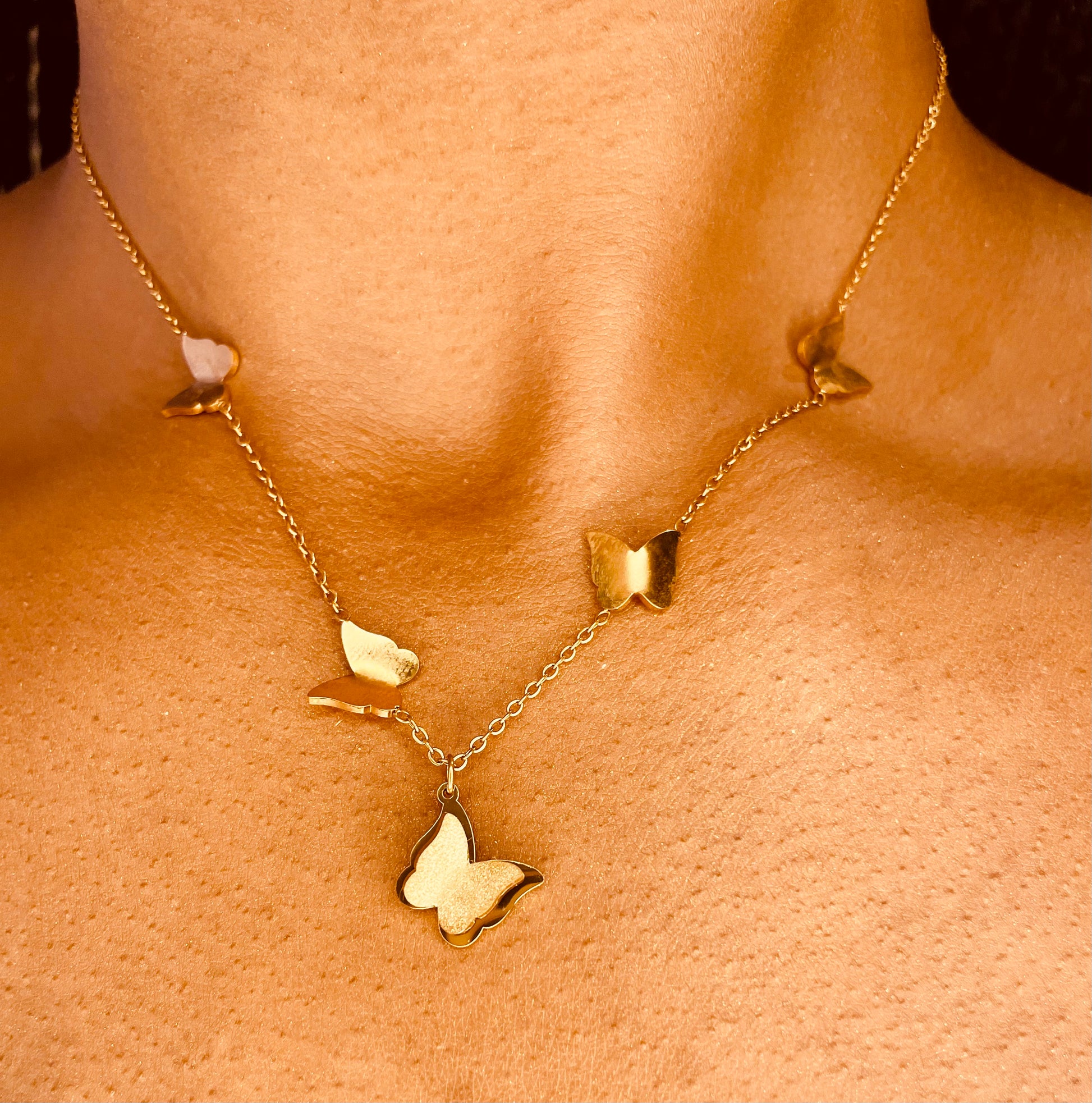 18K gold plated butterflies necklace worn by a model, showcasing its elegant and feminine charm.