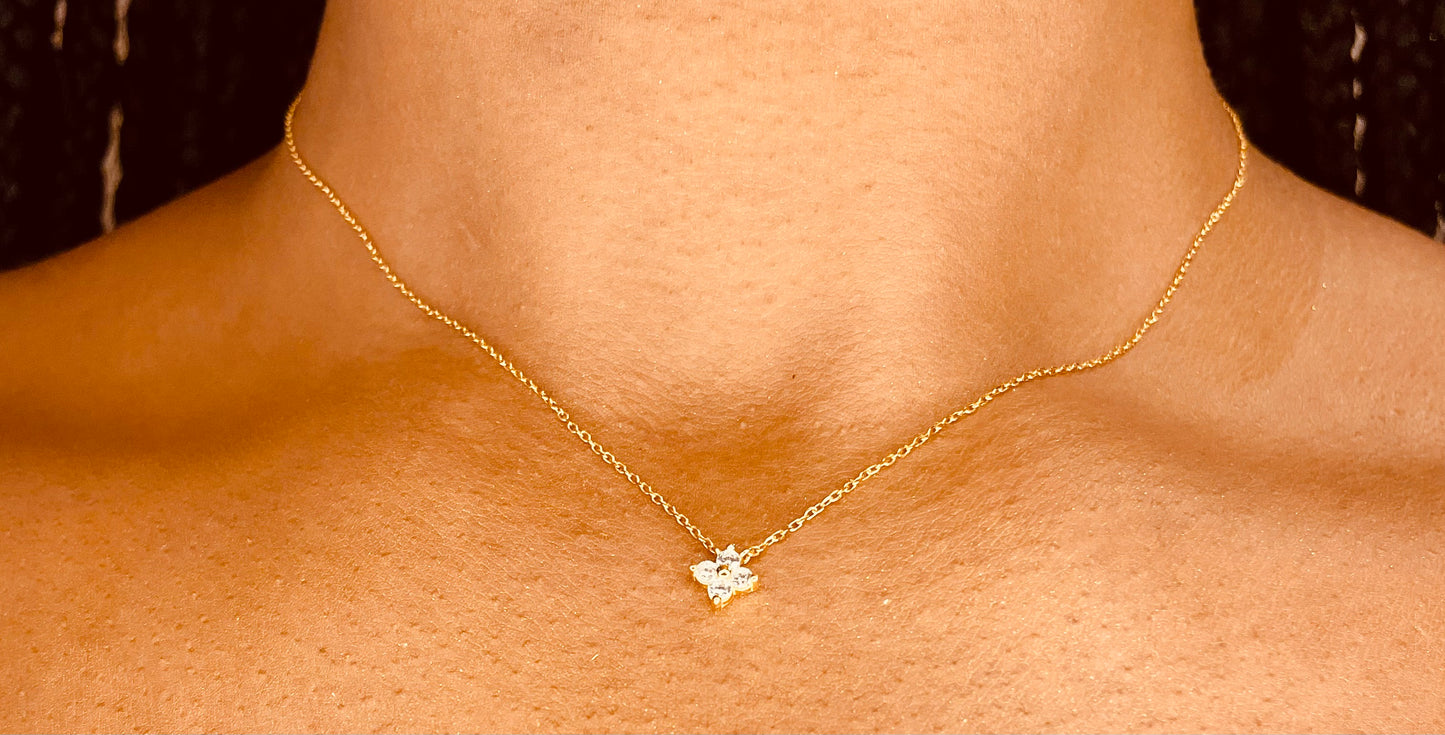 Single Four Leaf 18K gold plated 925 sterling silver necklace worn by a model, highlighting its chic and lucky charm from GeorgiaReneeBoutique.