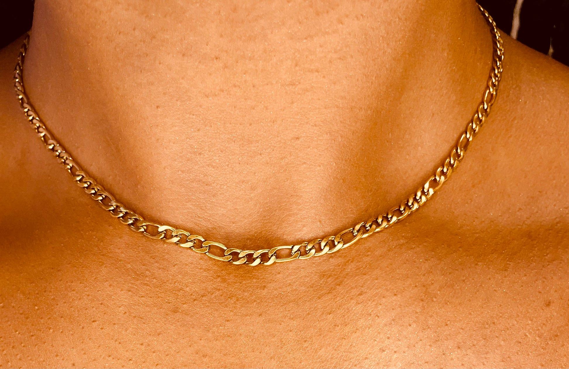  Side view of tarnish-proof 18K gold plated steel necklace, featuring a sleek and sophisticated design.