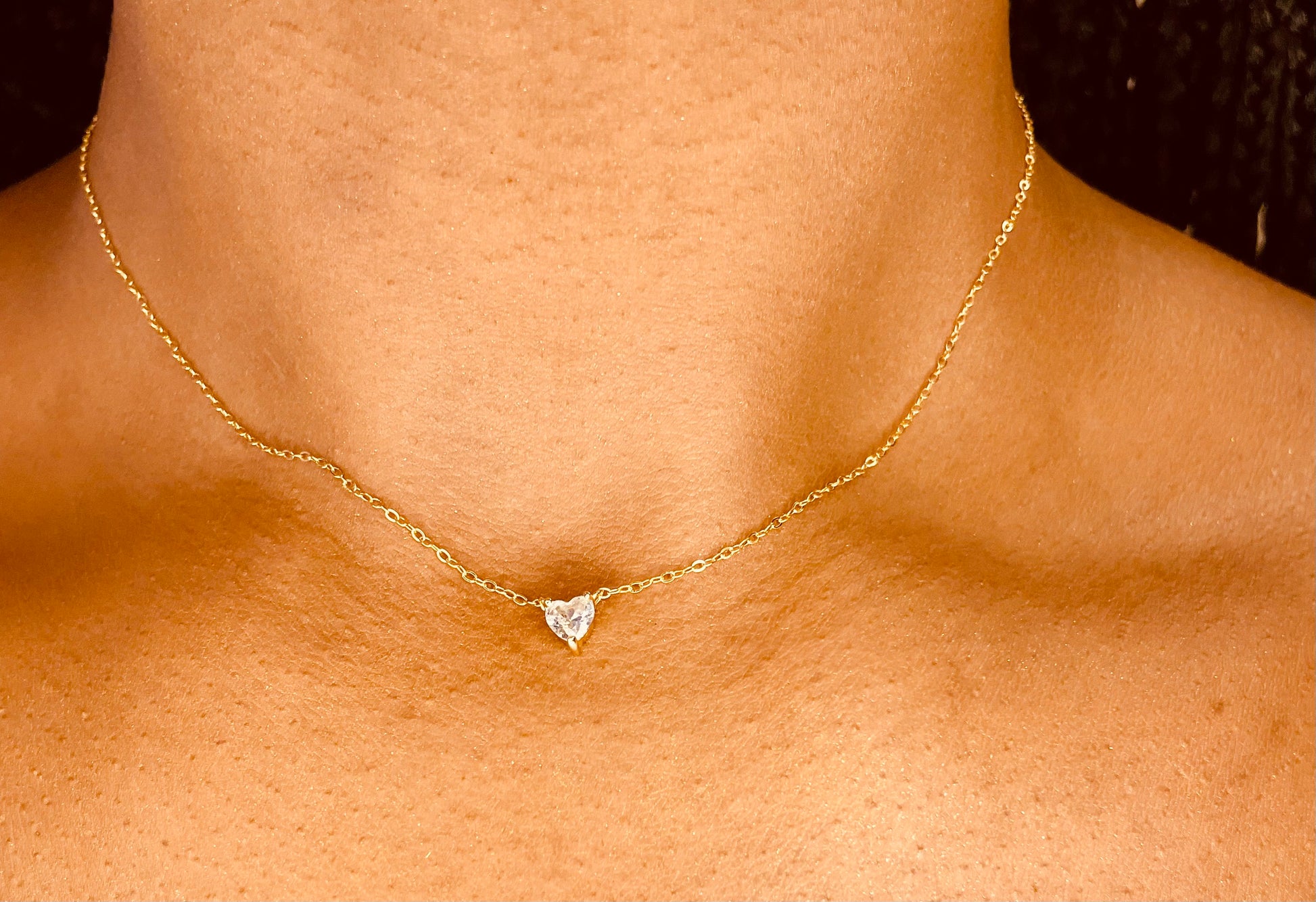 Dainty heart 18K gold plated necklace worn by a model, highlighting its feminine and versatile design from GeorgiaReneeBoutique.