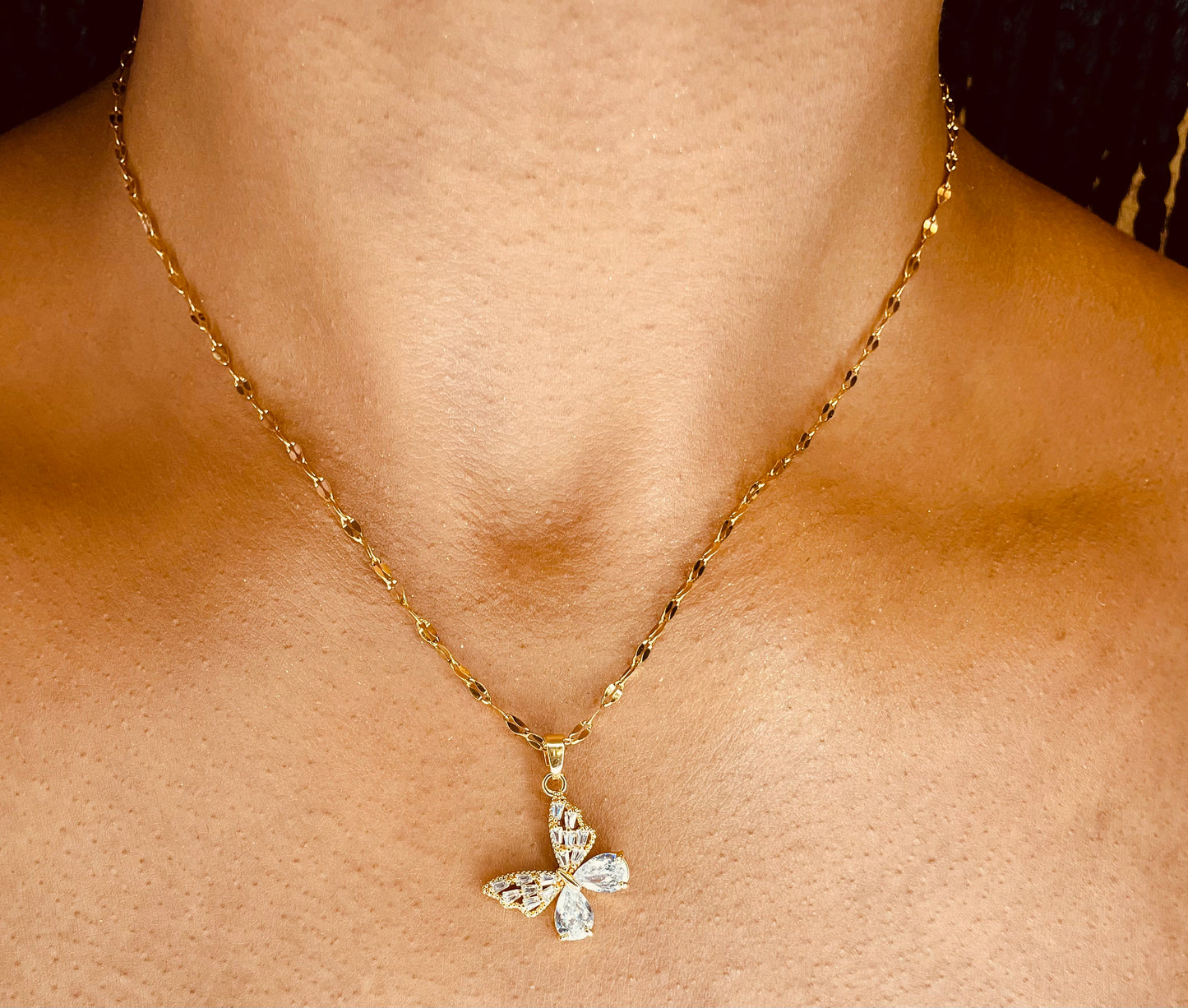  Stylish 18K gold plated steel butterfly necklace worn by a model, highlighting its delicate design from GeorgiaReneeBoutique.