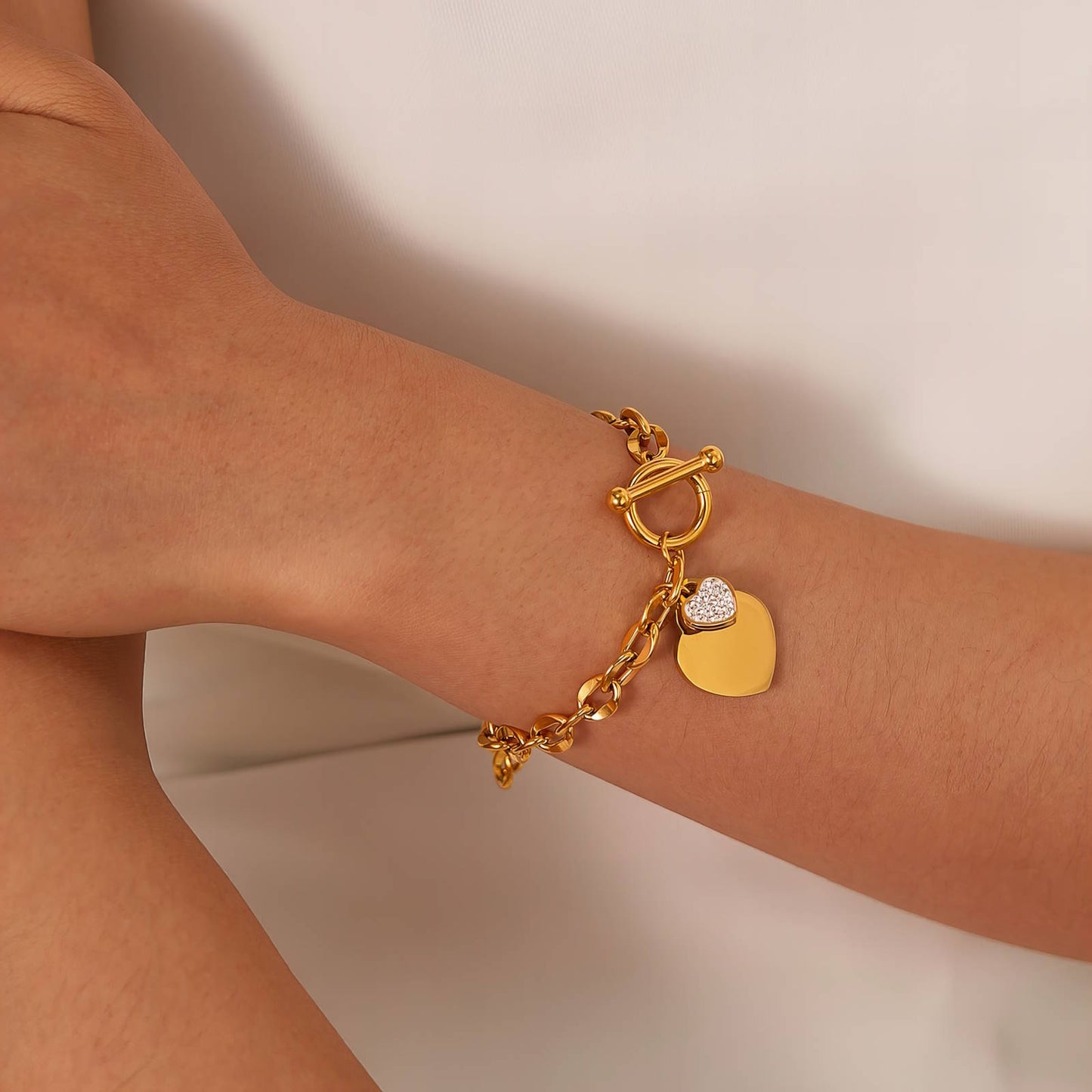 Stylish 18K gold plated hearts bracelet worn on wrist, designed with love by GeorgiaReneeBoutique.